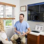 [LAST_NAME] speaking with a patient at Shoreline Oral Surgery & Dental Implants